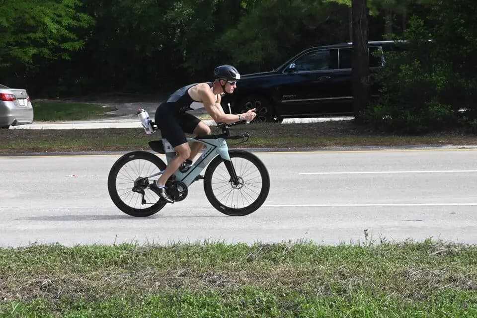 Dr. Marc Lewis riding the bike leg of a triathlon